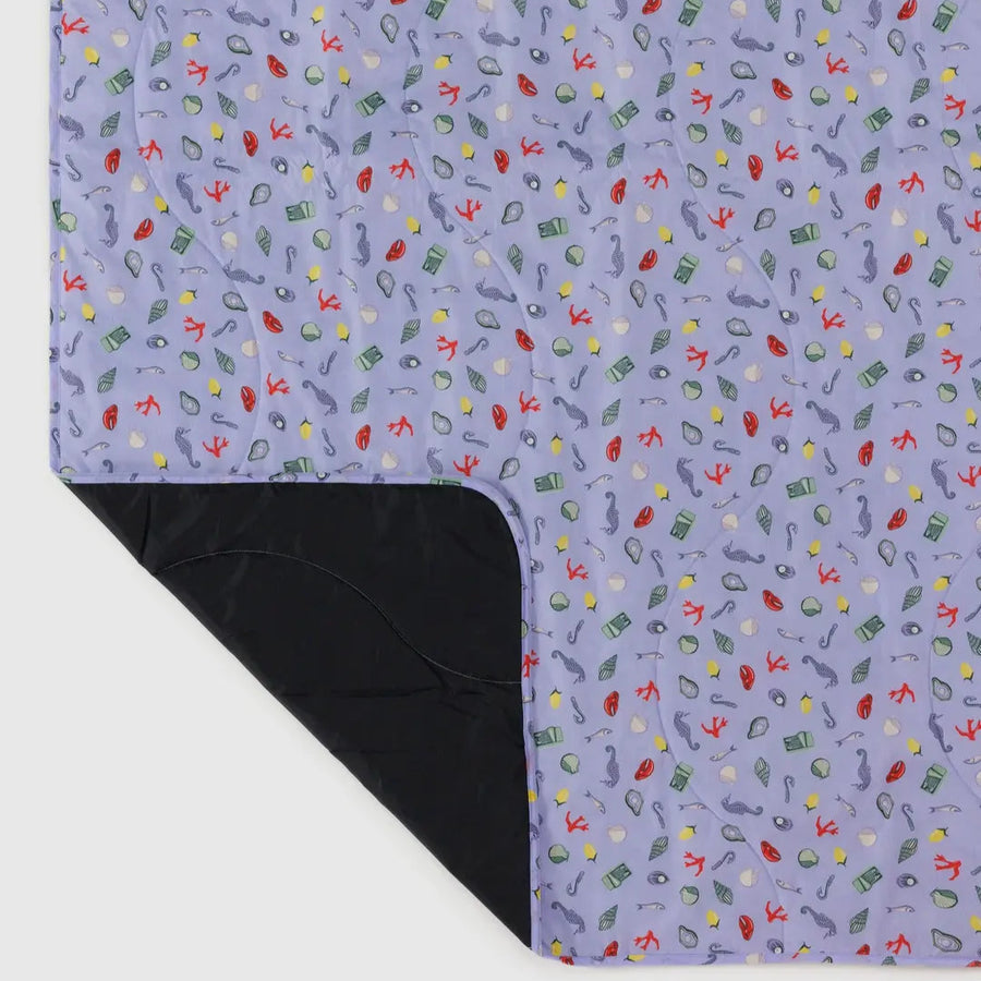Puffy Picnic Blanket, Sea Charms by Baggu, laid flat showing the waterproof back