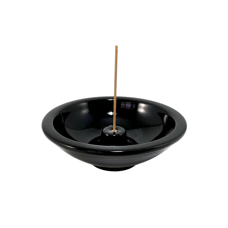 Ceramic Incense Wheel, Ebony by Shoyeido Incense, holding a burning incense stick