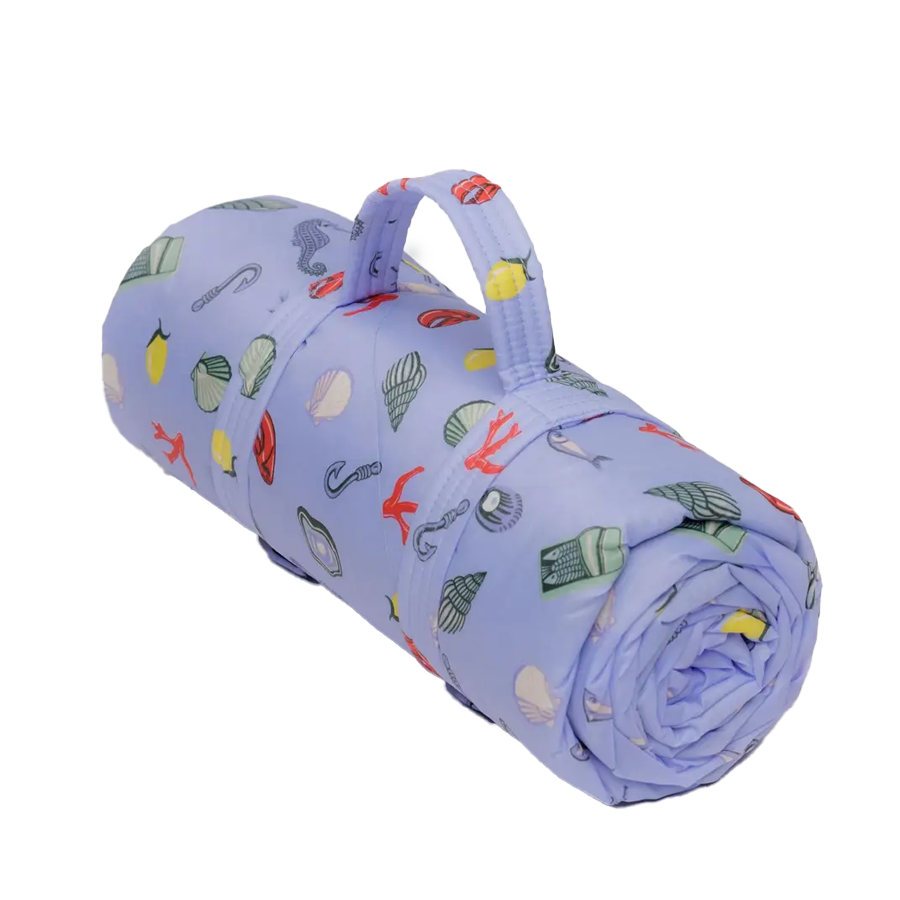 Puffy Picnic Blanket, Sea Charms by Baggu, rolled with a carry strap