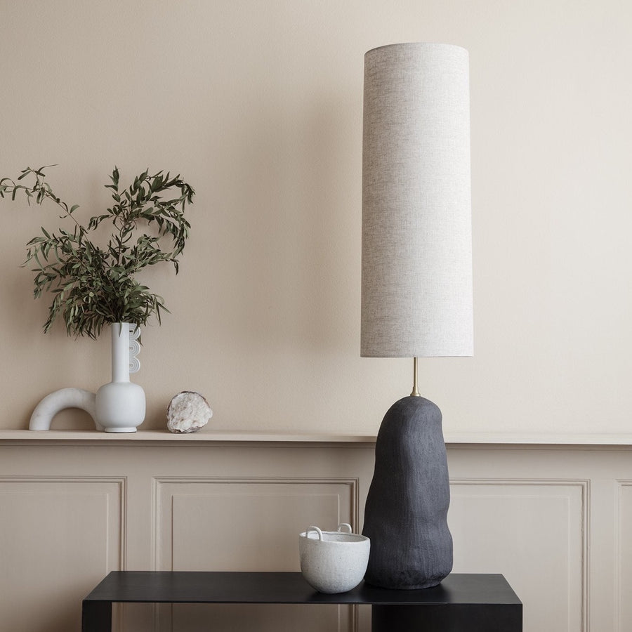 Hebe Lamp Base & Shade, Large, Dark Grey by ferm LIVING, on a console beside a plant