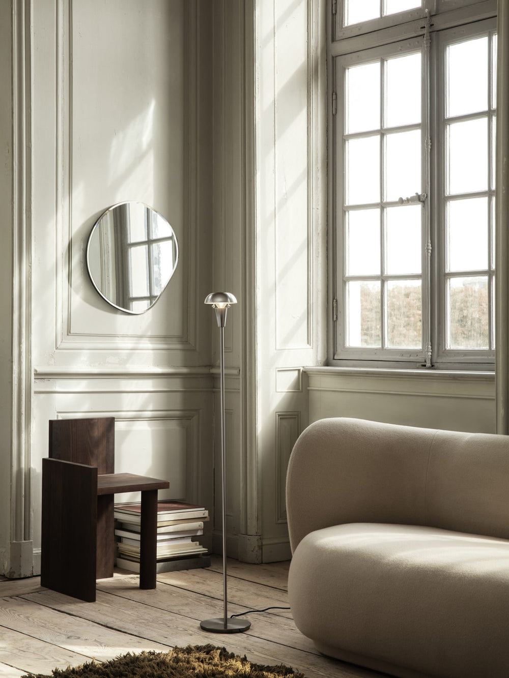 Pond Mirror, Extra Large, Brass by ferm LIVING, in a living room with a sofa