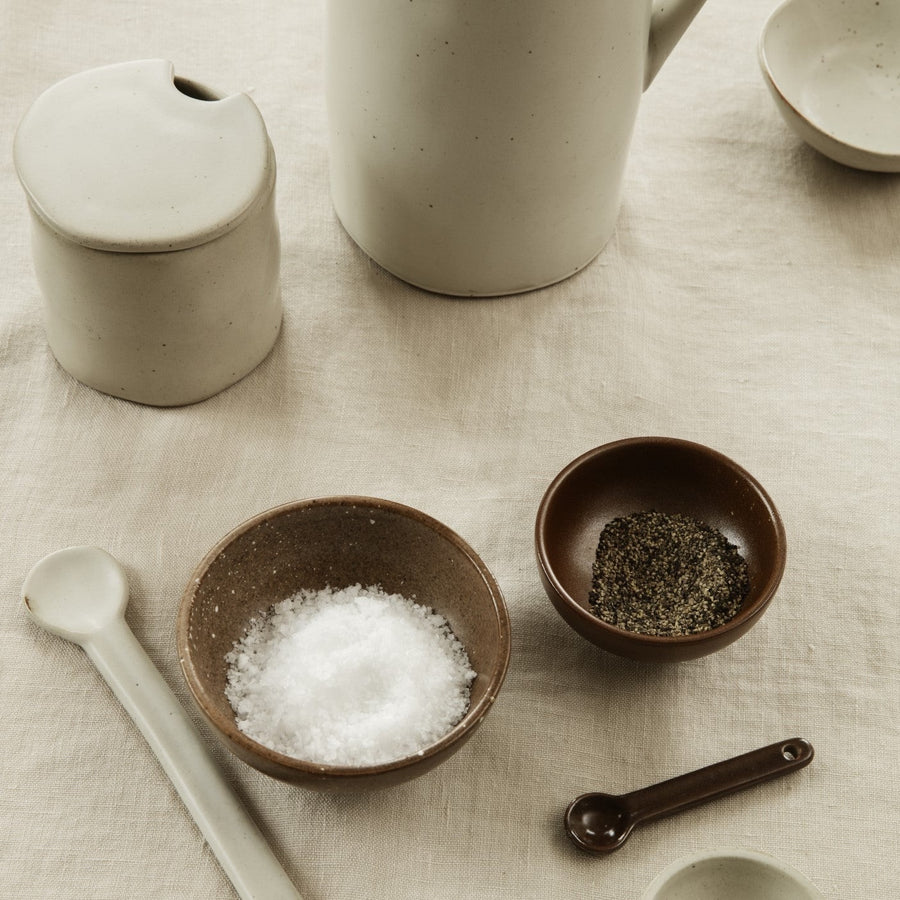 Flow Jam Jar, Off White by ferm LIVING, on a stone counter with salt