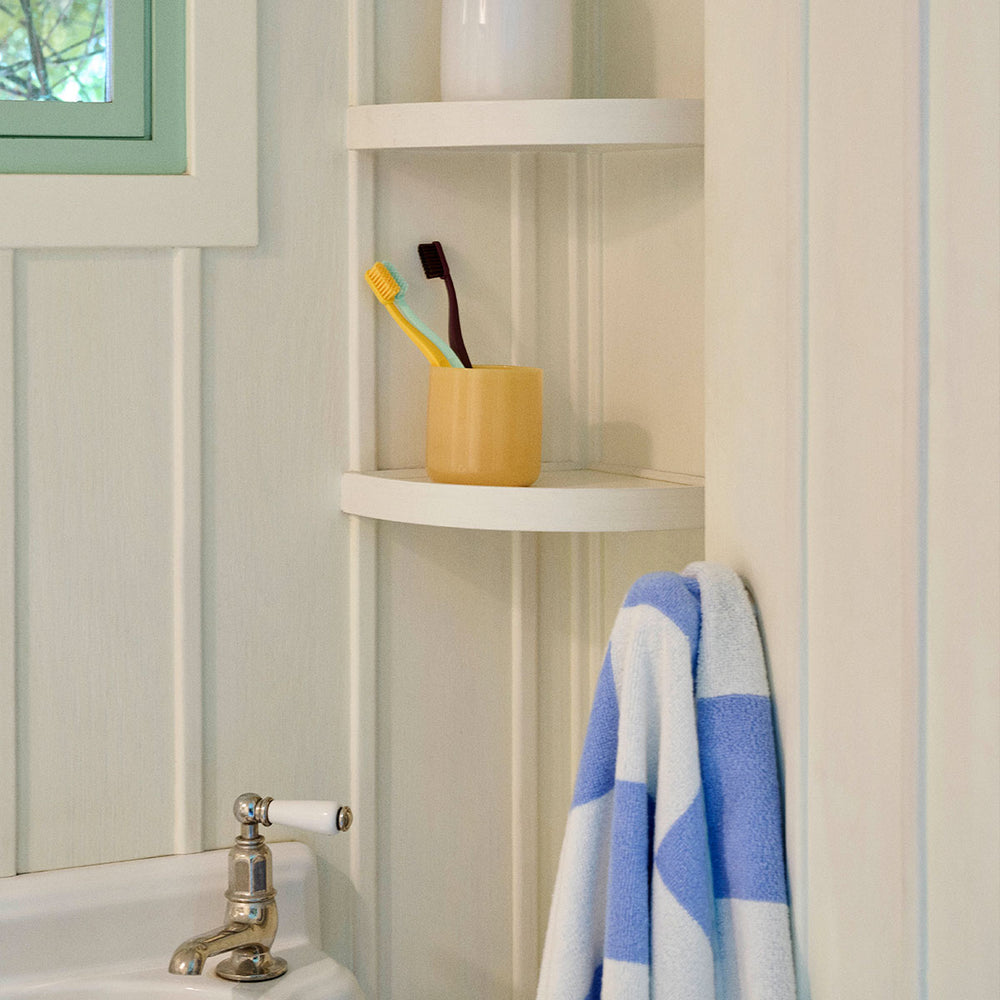 Cotton Hand Towel in Sky Blue by HAY, hanging in a bathroom