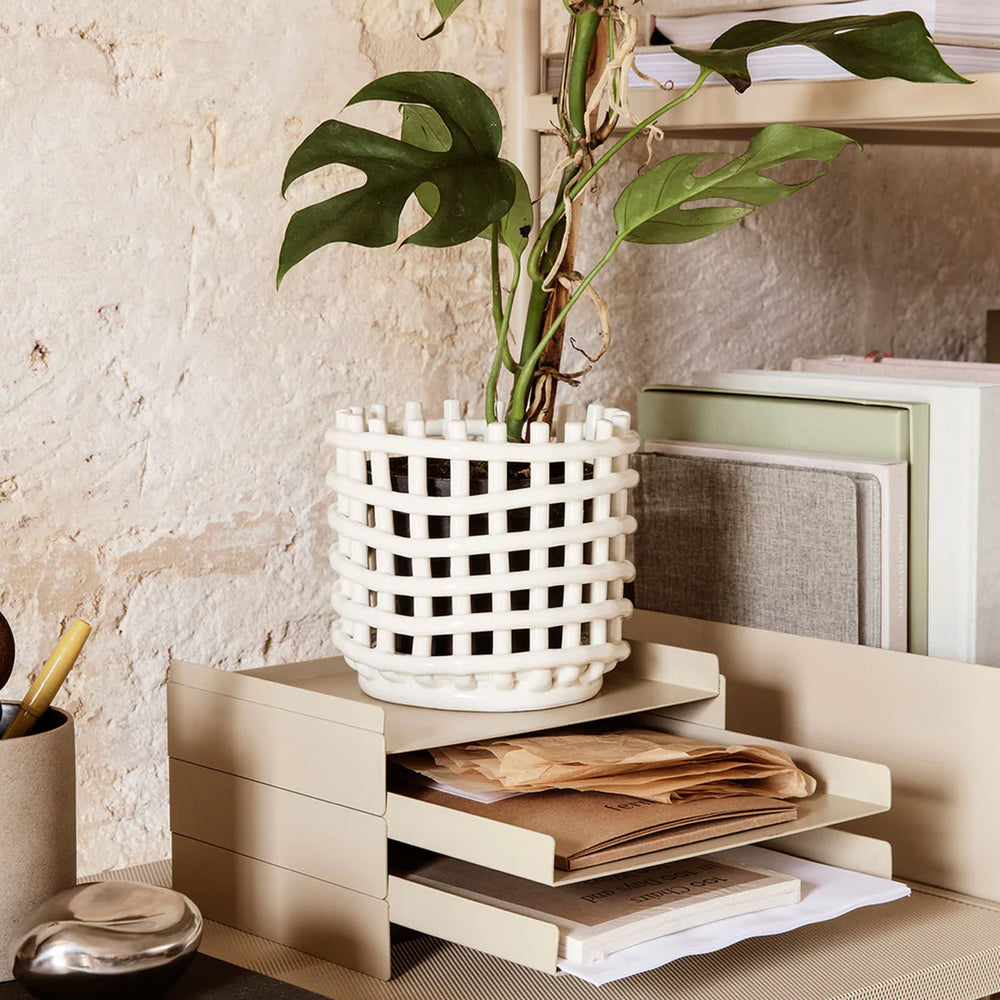 Ceramic Basket, Small, Off-White by ferm LIVING, holding a plant on a shelf