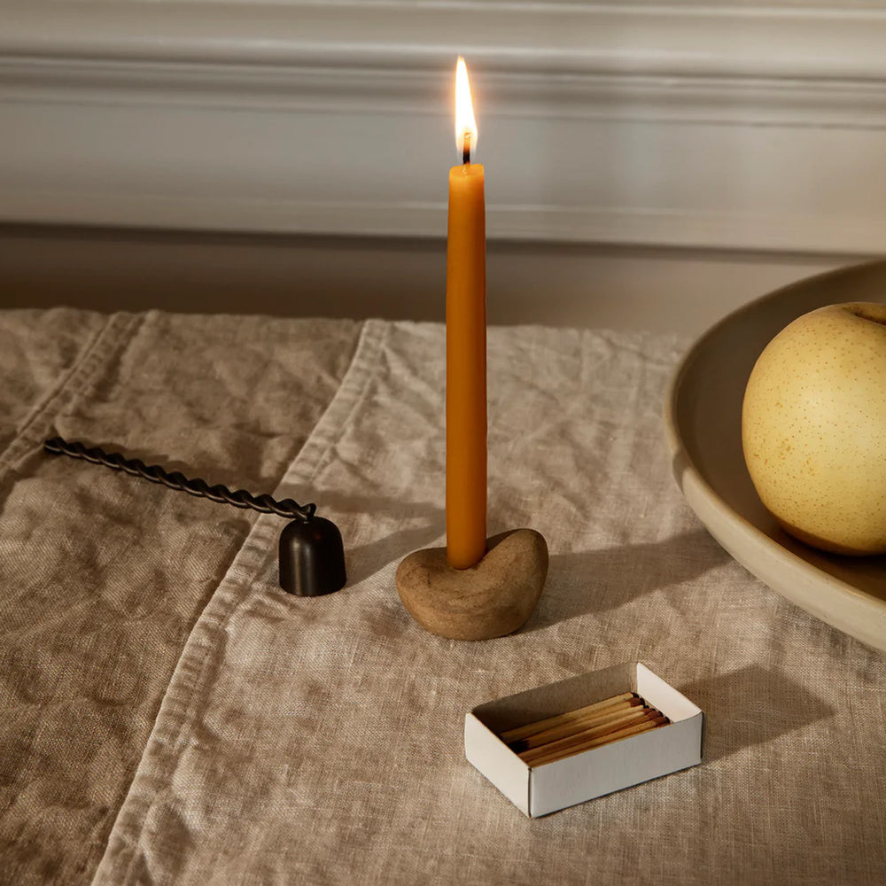 Libre, Candle Holder Gift Set by ferm LIVING, holding a lit taper on a stone table